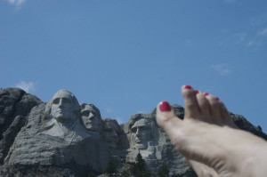Lou Nell's bare right foot w/pink toenails, Mt. Rushmore and blue sky ...