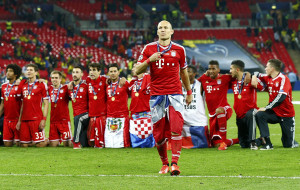 Arjen Robben walks near his kneeling team mates after defeating ...
