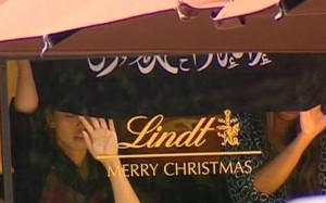 Flag with Islamic writing on visible in window of Lindt cafe in Martin ...