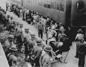 Japanese people being rounded up to be sent off to camp.