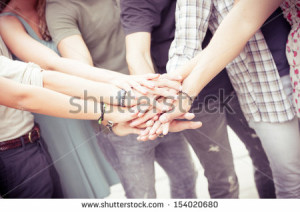 Group of friends pile up hands as unity oath,Italy - stock photo