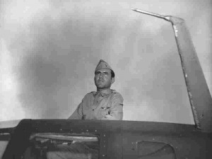 Louis Zamperini peers over the hatch nose of his aircraft in 1943 ...