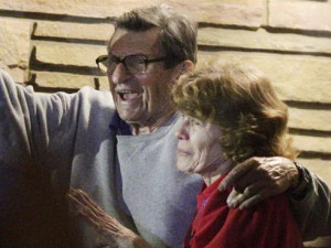 Joe Paterno and his wife wave to Penn State students.