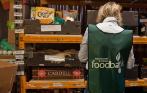 sorts through donations of food at the Hammersmith and Fulham food ...