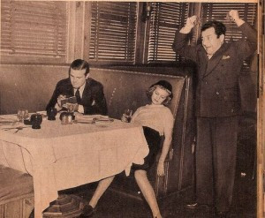 Old photo of a man at a dinner table, a woman passed out at the table ...