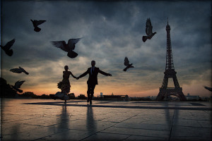 of couple holding hands, running through Eiffel Tower plaza at sunset ...