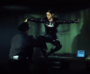 Trinity performs a flying kick on the Law Enforcement officer.