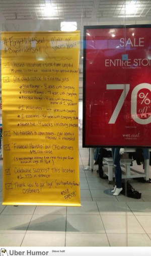 Employees leave a protest sign at failing Wet Seal mall store