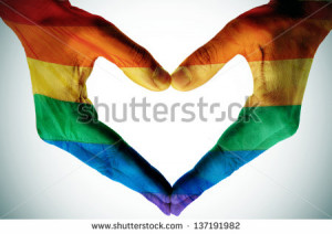 man hands painted as the rainbow flag forming a heart, symbolizing gay ...