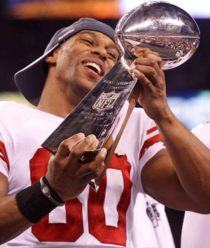 Victor Cruz holds the Vince Lombardi Trophy after his team defeated ...