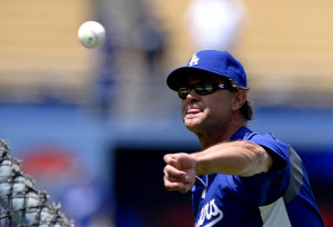 Dodgers Manager Don Mattingly pitches during batting practice before a ...
