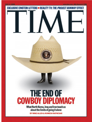 Cowboy hat, bearing presidential seal, with two small feet emerging