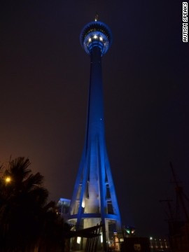 The Macau Tower next to the Pearl River in China lights up blue