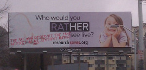 Third pro-animal research billboard spray-painted