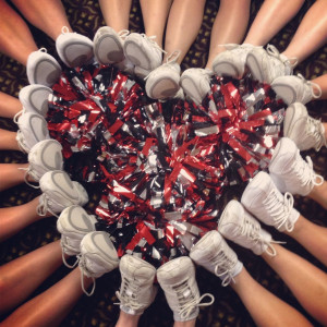 Cheer pom poms and feet int e shape of a heart. Photo found here .