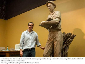 ... Victor stands with his clay sculpture of Norman Borlaug in progress