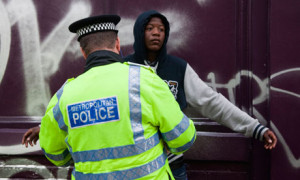 young black man is searched by a Metropolitan police officer in ...