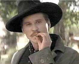 Doc Holliday is drunkenly playing a somber piece on the saloon piano ...