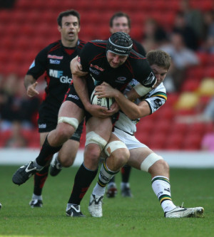 Steve Borthwick of Saracens is tackled by Alex Rae during the Guinness