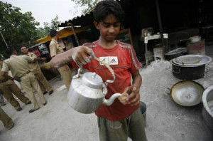 child labourer is seeb serving tea outside a roadside tea-stall in ...