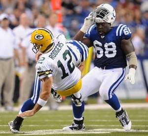 Bay Packers quarterback Aaron Rodgers is tackled by Indianapolis Colts ...