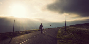 man-walking-watching-sunset-on-road-lovesove