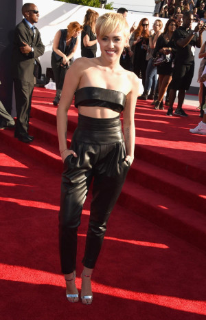 Miley Cyrus arrives to the 2014 MTV Video Music Awards.